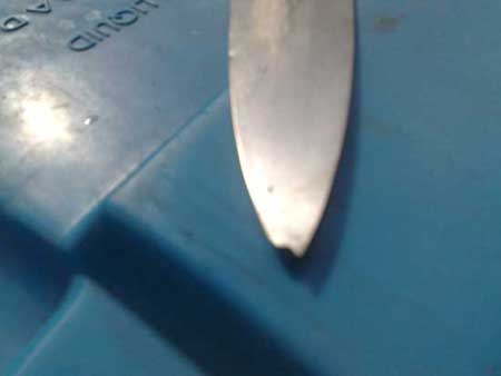 before image of knife with bent and damaged tip